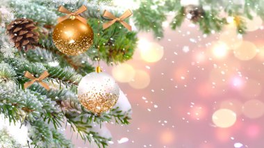 Christmas banner gold ball and green pine tree branch with cone winter blurred pink background copy space template banner