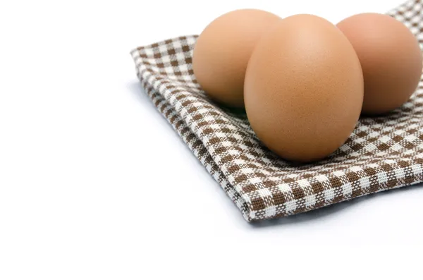 Eggs on tablecloth, isolated on white background — Stock Photo, Image