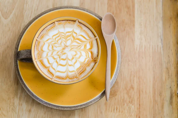 A Latte Coffee art on the wooden desk. — Stock Photo, Image