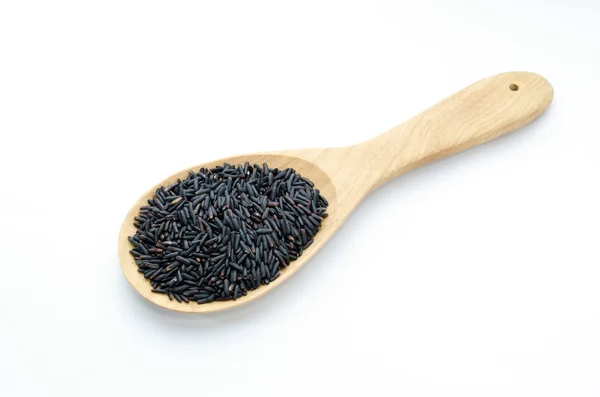 Rice berry on a wooden ladle. On a white background. — Stock Photo, Image