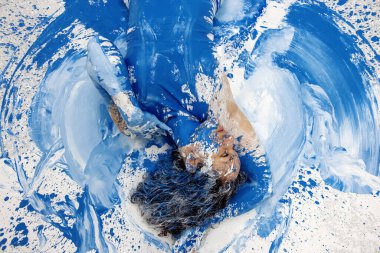 sexy, seductive, woman in underwear, artistically abstract painted with blue and white paint, lying on the colorful painted floor, copy space clipart