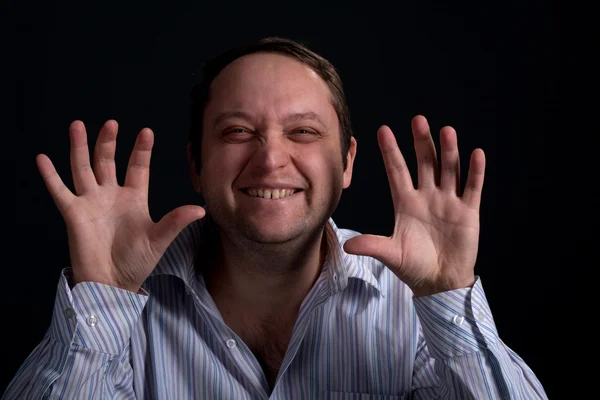 Young man with funny face in shirt and hands up — Stock Photo, Image