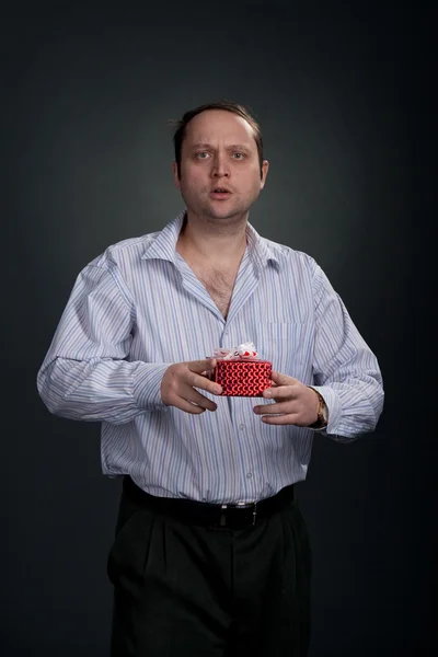 Sad man offering gifts — Stock Photo, Image