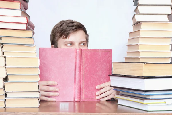 Man between books — Stock Photo, Image