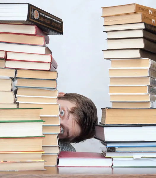 Man between books — Stock Photo, Image