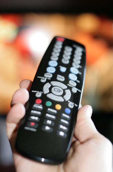 Hand pointing a tv remote control