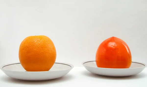 Fresh persimmon and orange — Stock Photo, Image