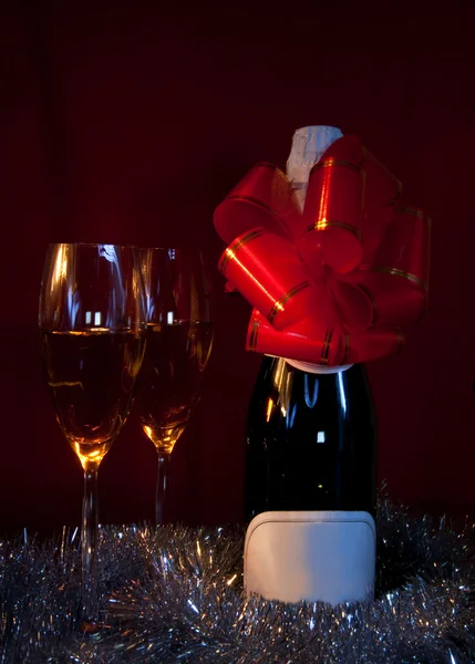 Two glasses of champagne over red background — Stock Photo, Image