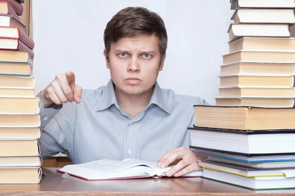 Man between books Royalty Free Stock Photos