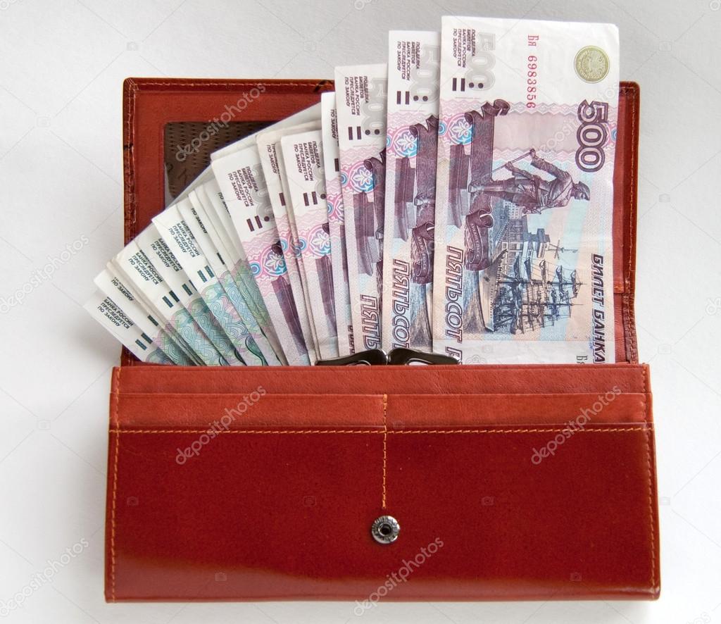 Orange leather wallet full of one hundred roubles