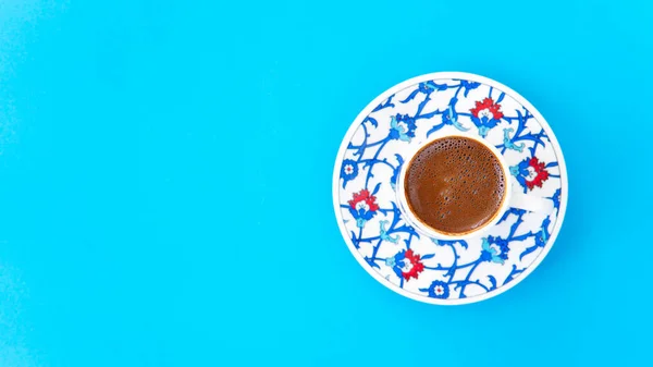 Turkish coffee on blue paper background.