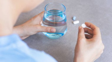 Woman taking her daily prescription pills