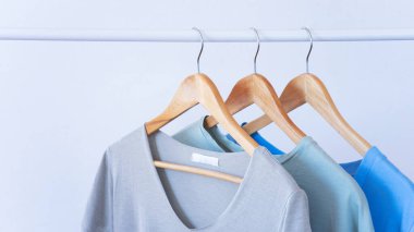 Women clothes hanging on wooden hangers in the store