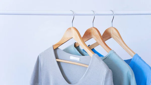 Women clothes hanging on wooden hangers in the store