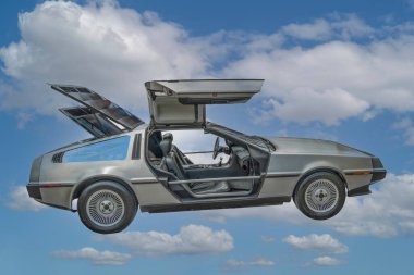 DeLorean DMC-12 car with doors up, back to the future car prototype against blue sky with white clouds