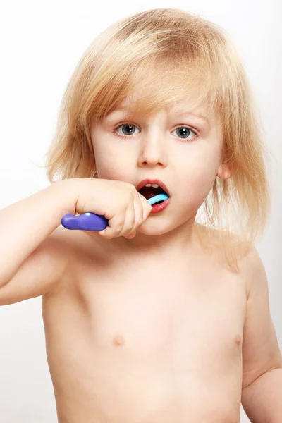 Cute boy brushing teeth Stock Photo