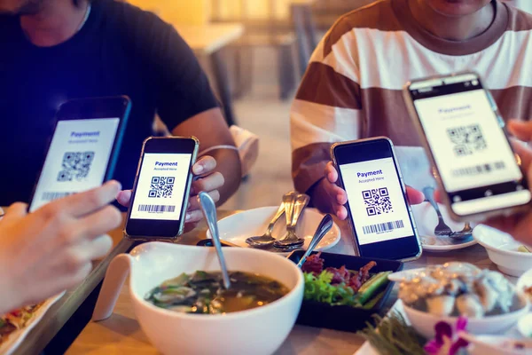 Selective focus to QR code tag and Barcode on smartphone in hands with blurry food and dessert in restaurant to accepted generate digital pay without money. QR code payment concept. Barcode Payment.