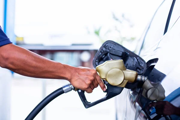 hand refilling the car with fuel at the gas  station, car in gas station, refilling the car with fuel at the refuel station, the concept of fuel energy.