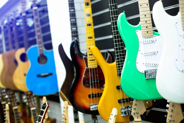 Selektywne Skupienie Się Gitarze Elektrycznej Rozmytymi Gitary Wiszą Salonie Muzycznym — Zdjęcie stockowe