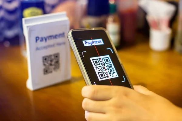 Customer hand using smart phone to scan QR code Tag to accepted generate digital pay without money. Qr code payment concept.