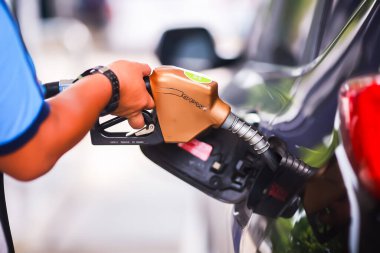 Benzin istasyonunda el yakıtını doldurmak, benzin istasyonunda araba doldurmak, yakıt istasyonunda yakıt doldurmak, yakıt enerjisi kavramı..