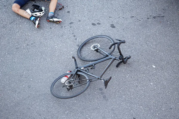 Bicycle accident on the road. Scene of a cyclist and bicycle on the asphalt after being hit by a vehicle