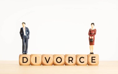 Divorce concept. Word on Wooden cube block and woman and man figurines. Copy space