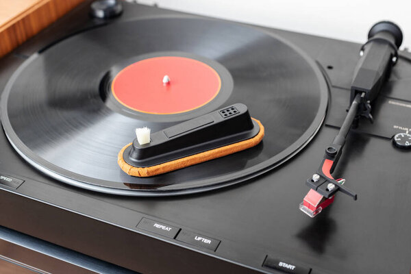 Cleaning tool on vinyl record. Cleaning concept