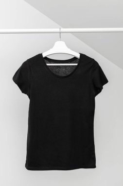 T-shirt hanging on Clothing rack. Round neck Black color. Template, mock up