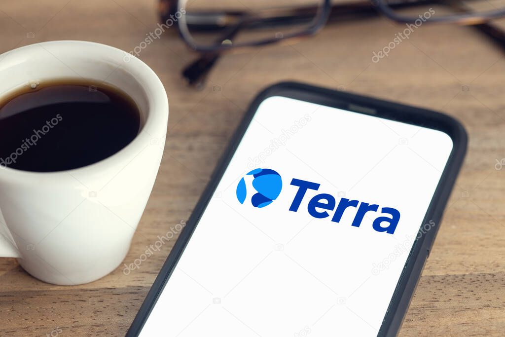 Galicia, Spain; february 15, 2021: Terra Luna logo on Smart phone screen on desk with a cup of coffee