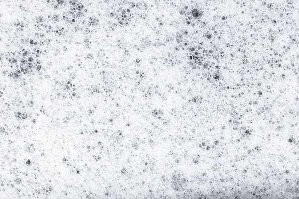 White Soap foam with bubbles background texture. Full frame