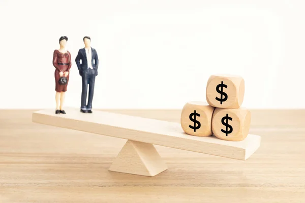 Life and Work or money balance concept. Couple figurine and dollar symbol on wooden blocks on wooden seesaw