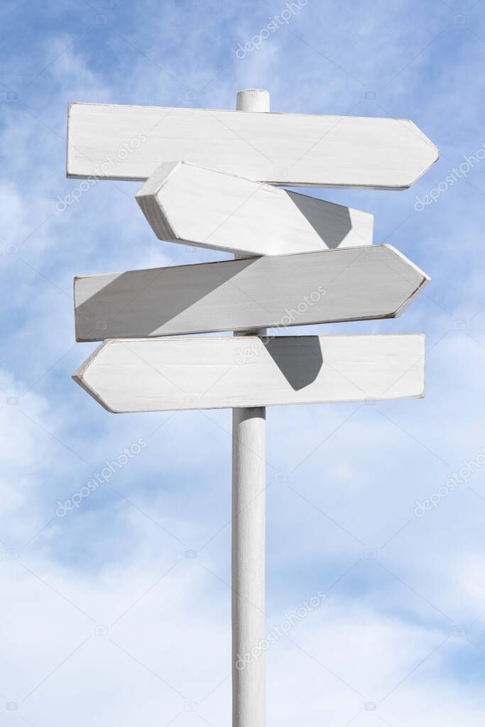 Blank white signpost on blue sky background. Choose the correct way concept. Mock up, template