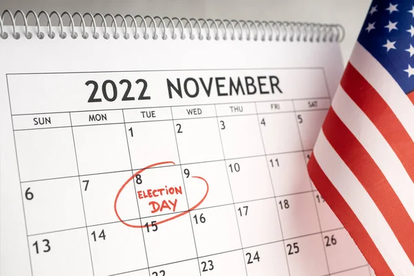 November 2022 USA election day concept. Desk calendar with November 8 marked in red and USA flag