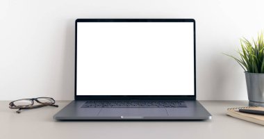 Modern laptop with blank white screen on minimalist desk. Template Mock up