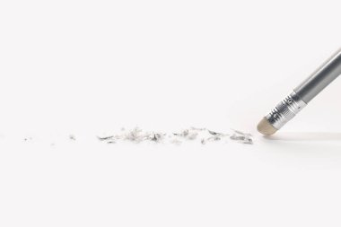 Pencil eraser working on white paper background. Mistake, erasing or correction concept. Copy space