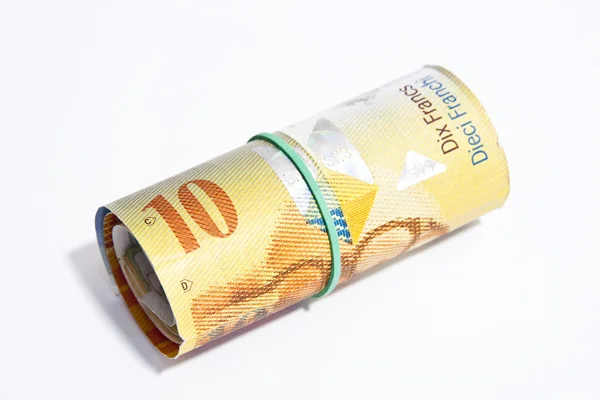 10 Zwitserse Franken in bankbiljetten gerold — Stockfoto