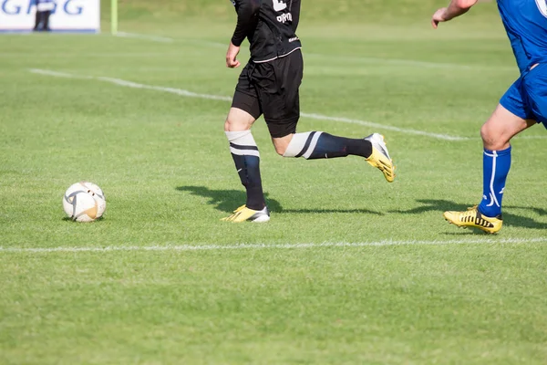 Soccer player kicks the ball — Stock Photo, Image