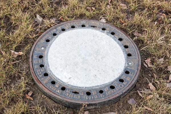 Sewer drain on the sidewalk in the city Stock Image