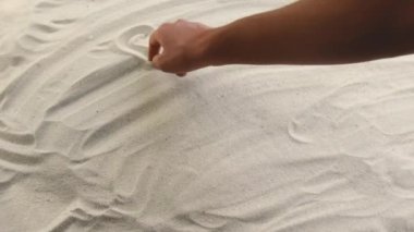 hand draws the inscription Sea of Azov on the sand. Sunny coast of the sea and ocean. Symbol of rest and vacations at the resort