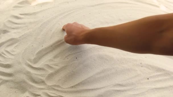 Hand draws the inscription China on the sand. Sunny coast of the sea and ocean. Symbol of rest and vacations at the resort — Stockvideo