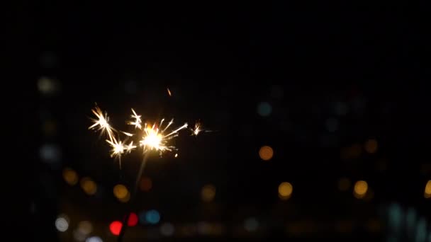 Bengal fire stick burns on a black background close up in slow motion. festive fireworks and bokeh — Wideo stockowe