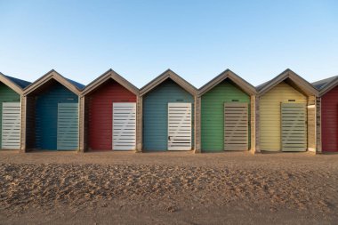 Blyth, Northumberland bölgesindeki plajın yanında birkaç kabin ya da kapalı soyunma odası, resim gibi ve eşsiz bir renk çizgisi oluşturur.