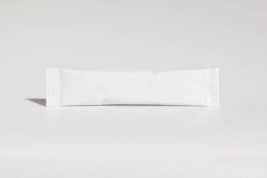 Mockup of isolated envelope of medicine, for powder, with blank label for packaging design, on white background, real photo studio, no 3D