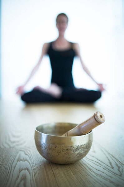 Woman yoga teacher in fitness studio stretching  and doing exercise