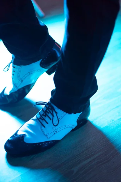 Male dancer teacher dancing in nightclub ballroom in jazz dance shoes.