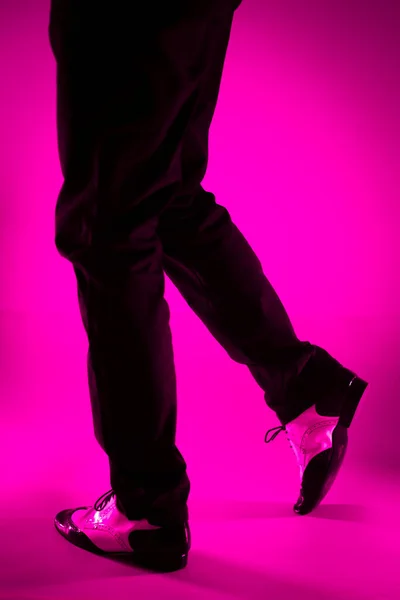 Male dancer dancing in jazz latin ballroom shoes with plain color background