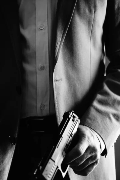 Retro secret agent with pistol revolver gun in hand in vintage crime thriller mockup cover     photo.