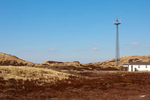 Radio tower between dunes — Stock Photo, Image