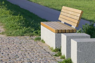 Modern bench on a grassy knoll 2 clipart